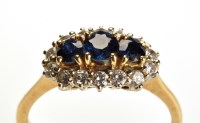 Lot 786 - A sapphire and diamond cluster ring, the three...