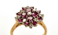 Lot 789 - A ruby and diamond cluster ring, set with...