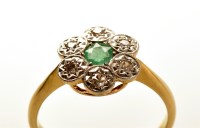 Lot 794 - An emerald and diamond cluster ring, the...