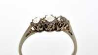 Lot 799 - A three stone diamond ring, the three...