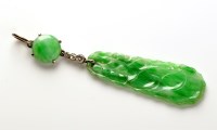 Lot 802 - A carved jadeite and diamond pendant, the...