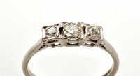 Lot 817 - A three stone diamond ring, the central...