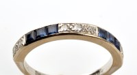 Lot 821 - A sapphire and diamond half hoop eternity ring,...