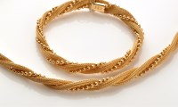 Lot 824 - An 18ct. yellow gold matching bracelet and...