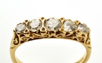 Lot 838 - A five stone diamond ring, the brilliant...