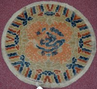 Lot 872 - A 19th Century Chinese circular rug, with...