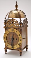 Lot 895 - A brass lantern style clock, with engraved...