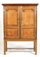 Lot 915 - An 18th Century oak cupboard with a pair of...