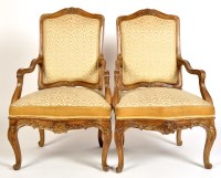 Lot 934 - A pair of Louis XV style walnut armchairs, the...