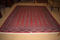Lot 1043 - A Turkoman style Pakistan carpet, red ground,...