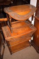 Lot 697 - A three-tier oak trolley with carved...