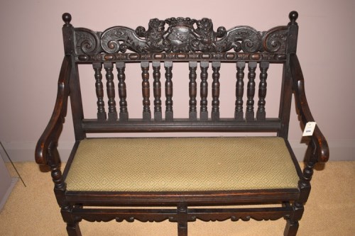Lot 834 - A dark stained carved bench seat, the cresting...