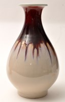 Lot 1085 - A modern drip glaze vase, in red and white...