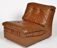 Lot 1131 - A modern brown leather easy chair, with button...