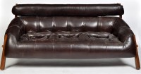 Lot 1132 - A teak and brown leather three-seater settee,...