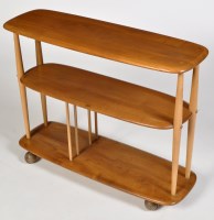Lot 1168 - Ercol: a light elm and beech trolley bookcase,...