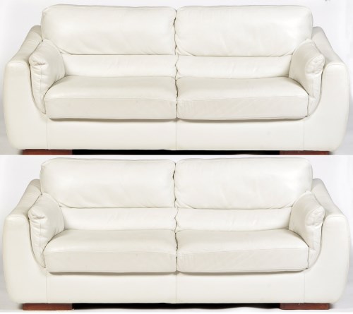 Lot 1171 - A pair of modern white leather two-seater...
