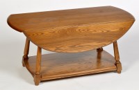 Lot 1198 - Ercol: an elm drop leaf coffee table, the oval...