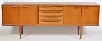 Lot 1217 - Younger: a 1960's teak sideboard, with four...