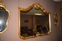 Lot 1253 - A modern rococo style wall mirror, shell and...